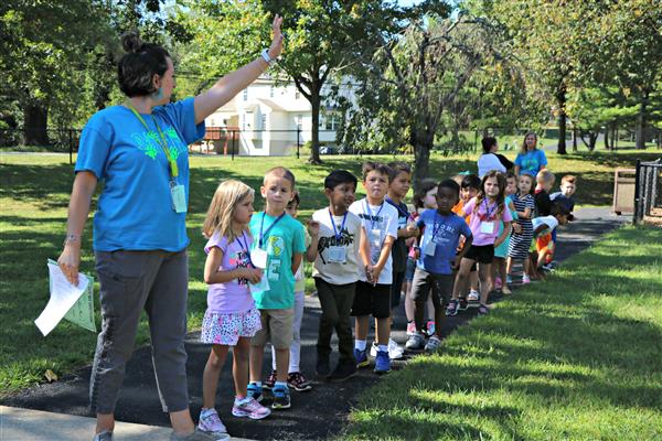 Kindergartners prepare to board a bus and talk about bus safety 